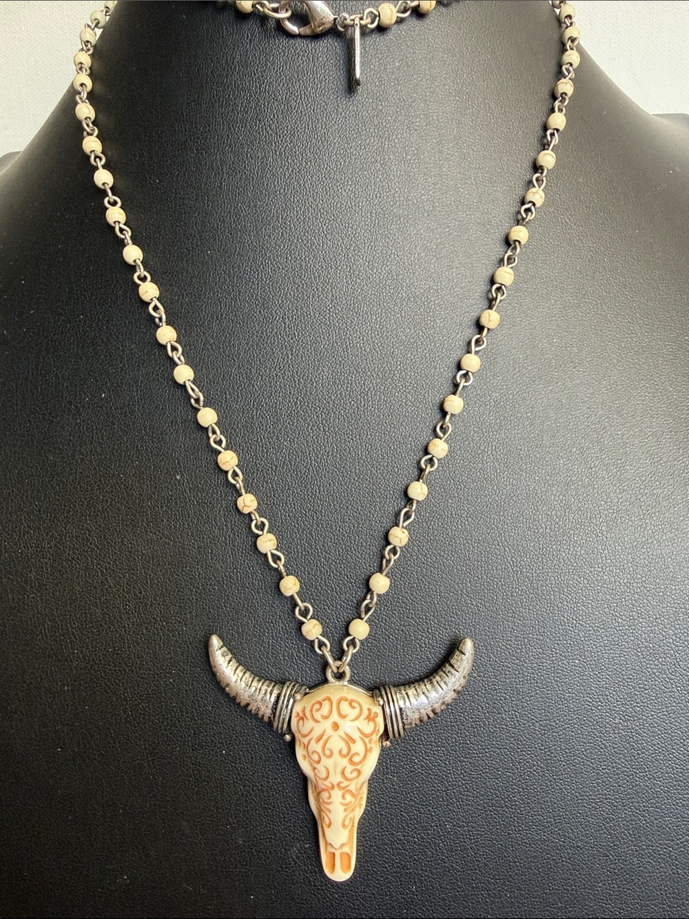 Southwestern style bull skull pendant on cream-colored chain necklace
